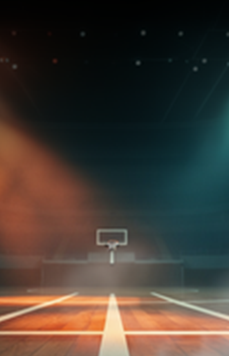 Basketball court under dramatic lighting with hoop in the background.
