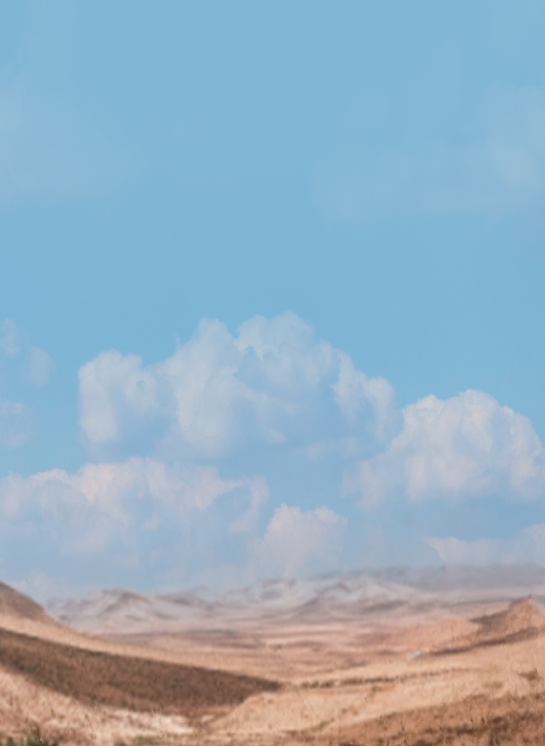 Wide desert landscape with rolling sand dunes beneath a bright blue sky and soft white clouds, featuring a cinematic post-apocalyptic wilderness aesthetic with a blurred gradient overlay.